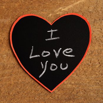A chalkboard message with I Love You handwritten inside a heart shape.