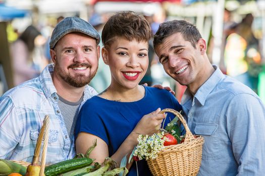 Friends with baskets of produce at farmers market
