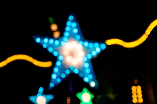 Abstract star shape bokeh light night background of town.