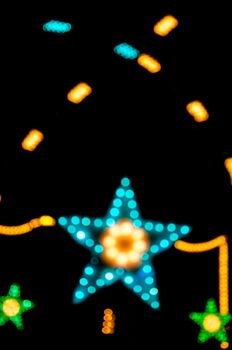 Abstract star shape bokeh light night background of town.