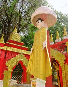 Golden statue buddha at Kyaw Aung San Dar monastery in Amarapura, Mandalay, Myanmar.