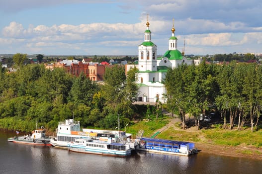 Voznesensko-Church of St. George and boats at the mooring on the Tura River in Tyumen, Russia. May, 2016
