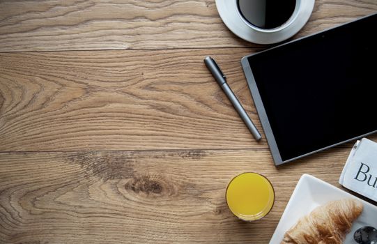 Breakfast with digital tablet on a wooden background with space