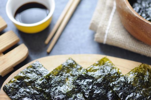 Seaweed wafer snacks on a wooden board closeup