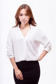 Attractive Asian American businesswoman in white blouse and black skirt looking at camera