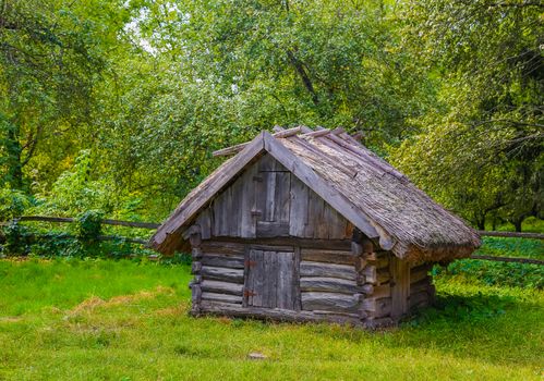 Ancient traditional Ukrainian barn with a straw roof. Rural concept.