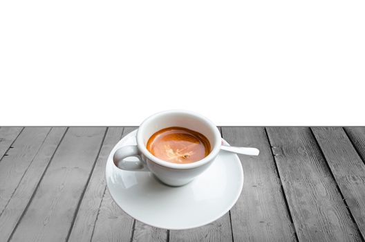 Cup of coffee on a wooden board against white background.