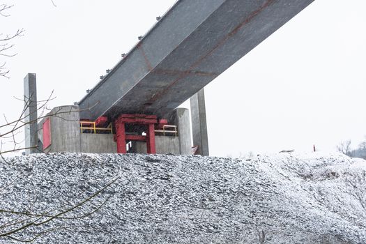 Bridge construction sites, bridge under construction seen in heavy snowfall from below.