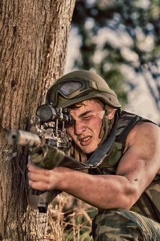 young a soldier in the uniform with weapon