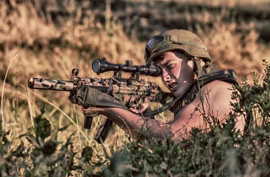 young a soldier in the uniform with weapon