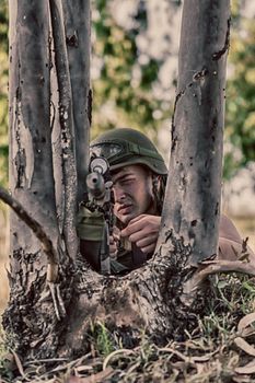 young a soldier in the uniform with weapon