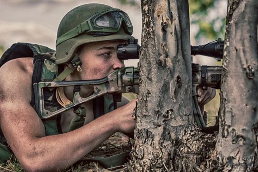 young a soldier in the uniform with weapon