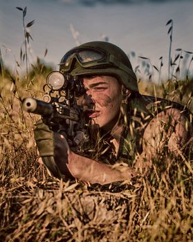 young a soldier in the uniform with weapon