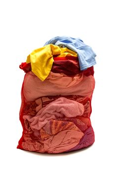 Vertical shot of red mesh laundry bag full of laundry.  Isolated on white background