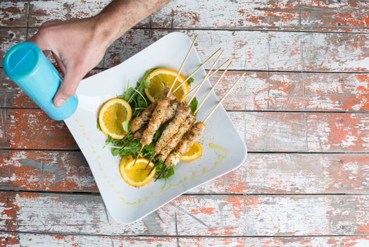 chicken skewer in a dish with olive oil