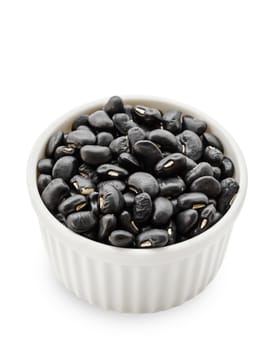 black bean seeds in white bowl isolated on white background.