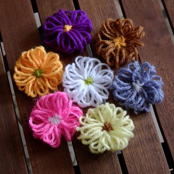 Group of handmade craft for mother day, colorful daisy flower on wood background, ornament make from yarn