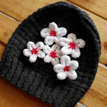 Group of handmade product for mother day, white daisy flower on wool background, make by knit from yarn