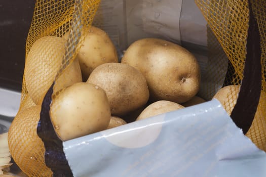 Yellow potatoes in an open transport bag
