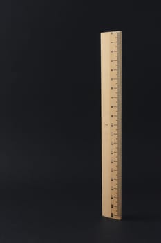 A wooden row of twenty centimeters isolated on a black background