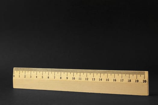 A wooden row of twenty centimeters isolated on a black background