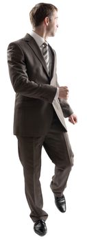 Full length portrait of young business man walking while looking back, away from the camera isolated on white background