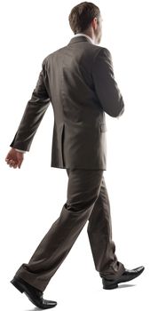 Caucasian young man with short dark hair in business formal outfit walking away isolated on white background