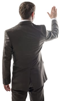 Rear view of young business man touching at copy space isolated over white background. Portrait of businessman standing back