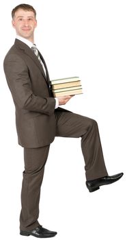 Businessman holding books and looking at camera isolated on white background