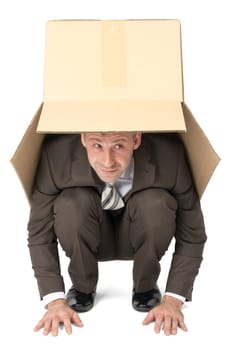 Businessman hiding under box isolated on white background