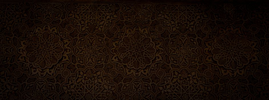 Wall detail of Alhambra UNESCO site in Granada - South of Spain. 600 years old arabic characters.