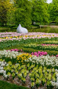 Drop monument with colorful daffodils and tulips, Keukenhof Park, Lisse in Holland.