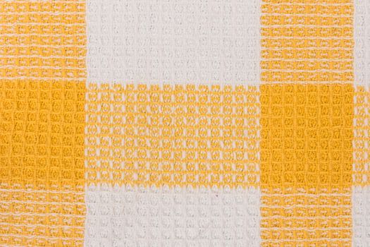 Yellow and white chess towel fabric. Tablecloth texture. Cotton texture closeup, background