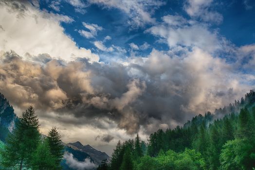 Thunderstorm formation over the mountains, dramatic sky of summer season