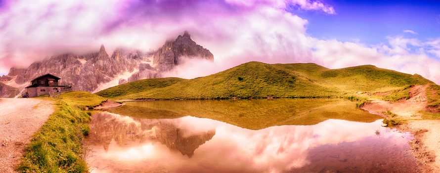 Small lake and panoramic views of the Pale di San Martino, Dolomiti - Italy