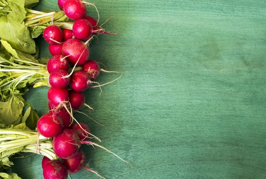 Fresh red radish on wooden background