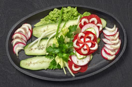 Chopped vegetables, on a black wooden background, food design