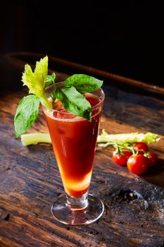 Cocktail Bloody Mary with ice in glasses on a wooden table