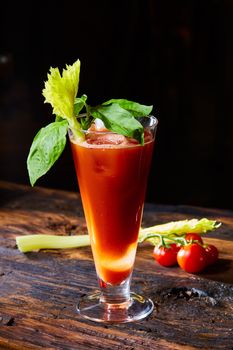 Cocktail Bloody Mary with ice in glasses on a wooden table