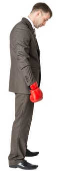 Sad businessman in boxing gloves isolated on white background