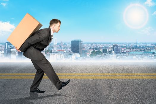 Image of business man carrying brown package on his back