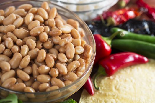 Cooked pinto beans and other ingredients for Mexican cooking.