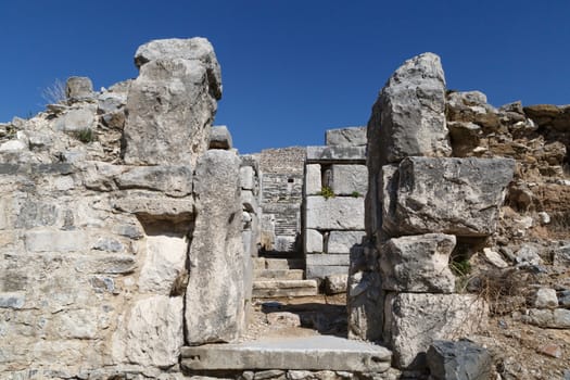 View of Miletus Ancient City ruins in Aydin, Turkey from prehistoric time, on bright blue sky background.