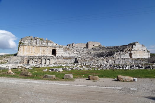 View of Miletus Ancient City ruins in Aydin, Turkey from prehistoric time, on bright blue sky background.