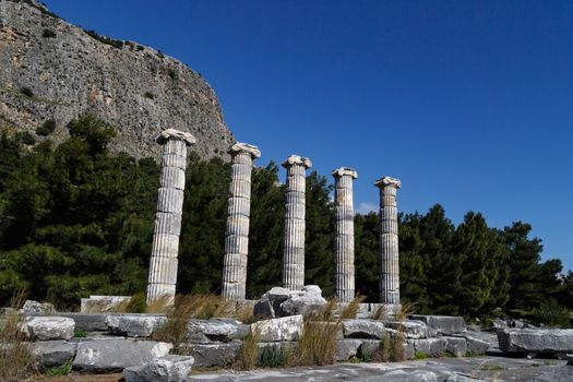 General temple view of Priene Ancient City in Aydın, Turkey, on bright blue sky background.