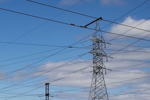 industrial bearing high voltage power lines against the sky