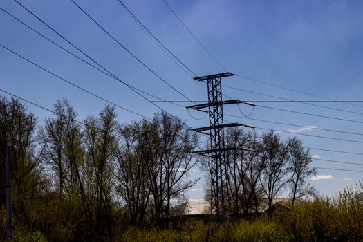 industrial bearing high voltage power lines against the sky