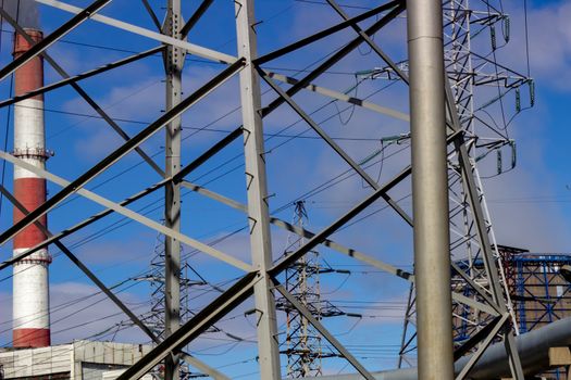 industrial bearing high voltage power lines against the sky