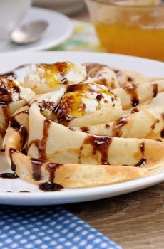 Pancake folded in the form of a snail cottage cheese with chocolate