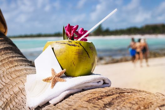 Coconut cocktail starfish tropical Caribbean beach refreshment and towel